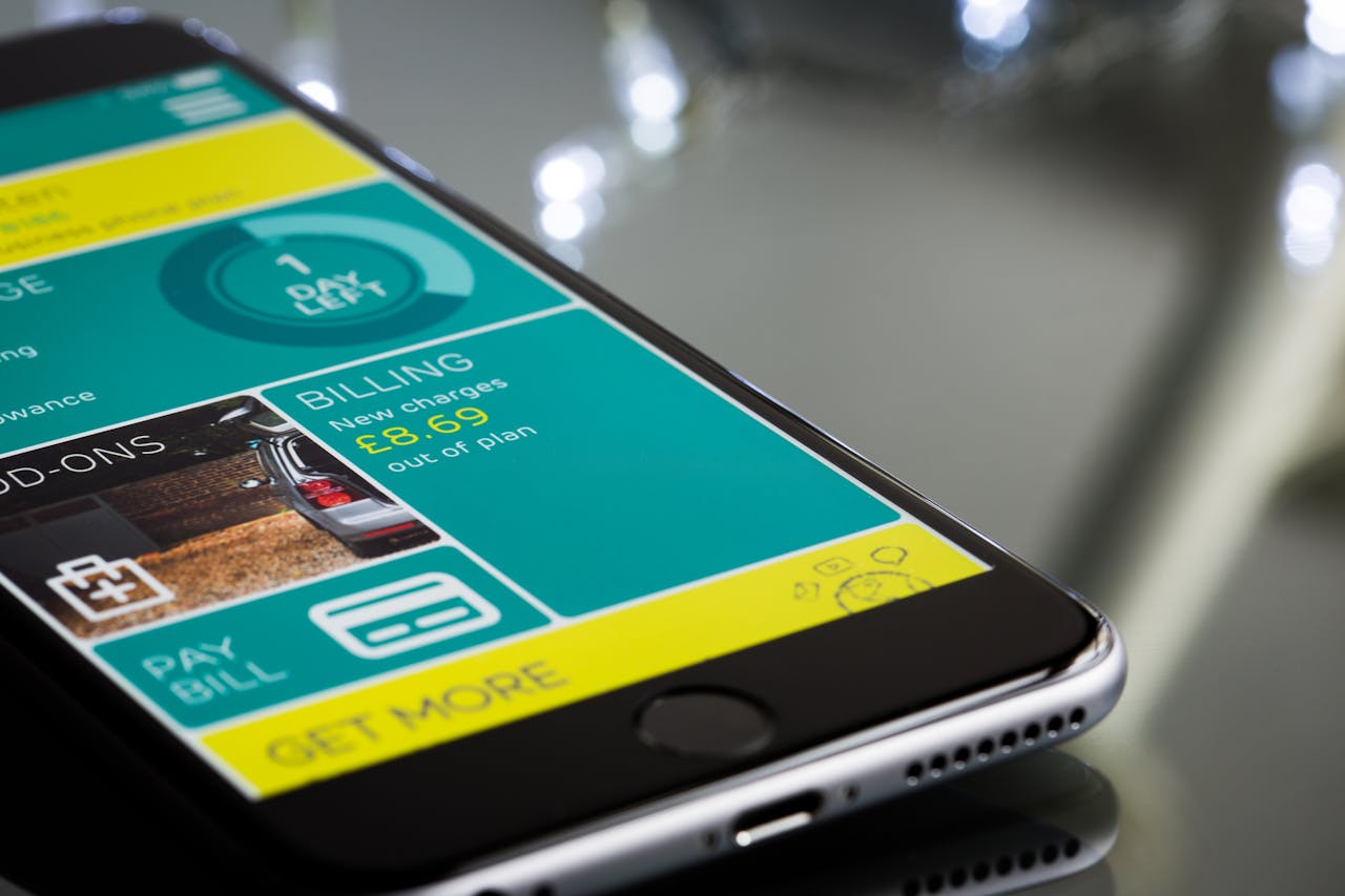 creative Close-up of a smartphone displaying a billing app interface on a reflective surface.