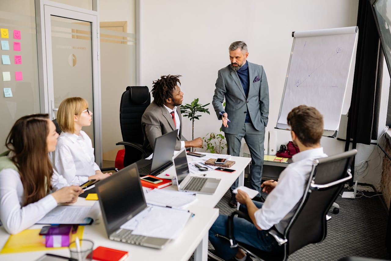 digital Corporate team in a modern office, engaged in a discussion with diverse colleagues.